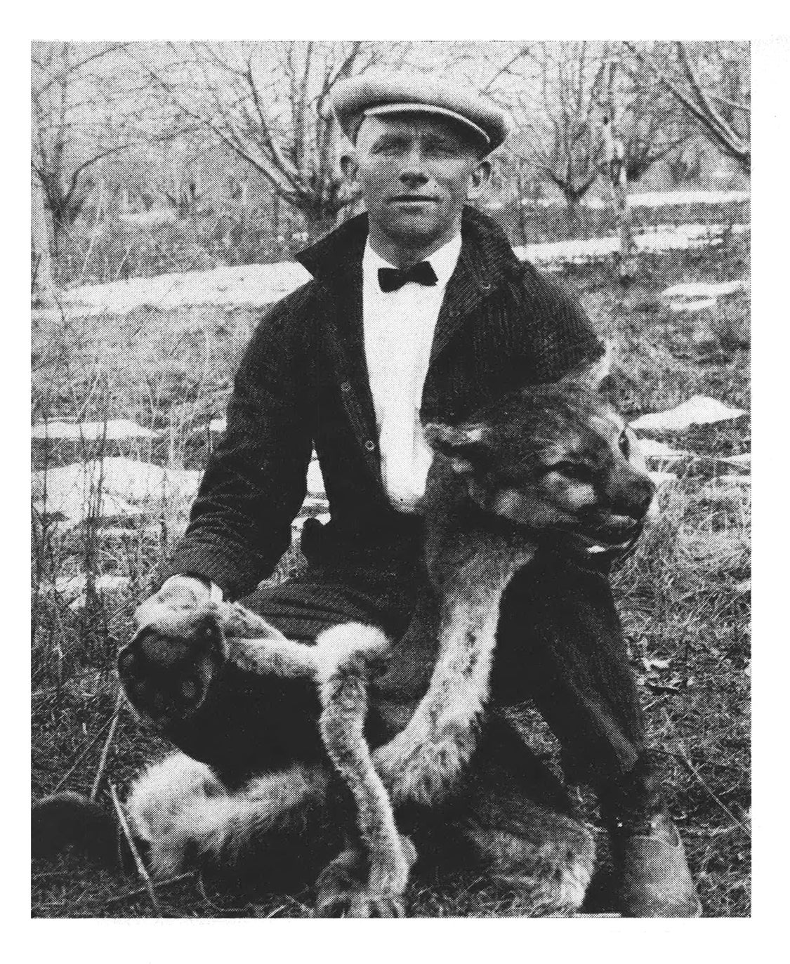 B&W magazine photo of author with cougar skin