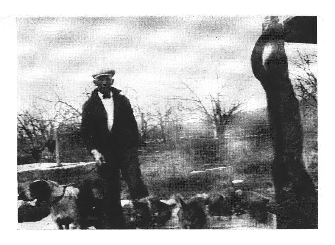 B&W magazine photo of author with dogs