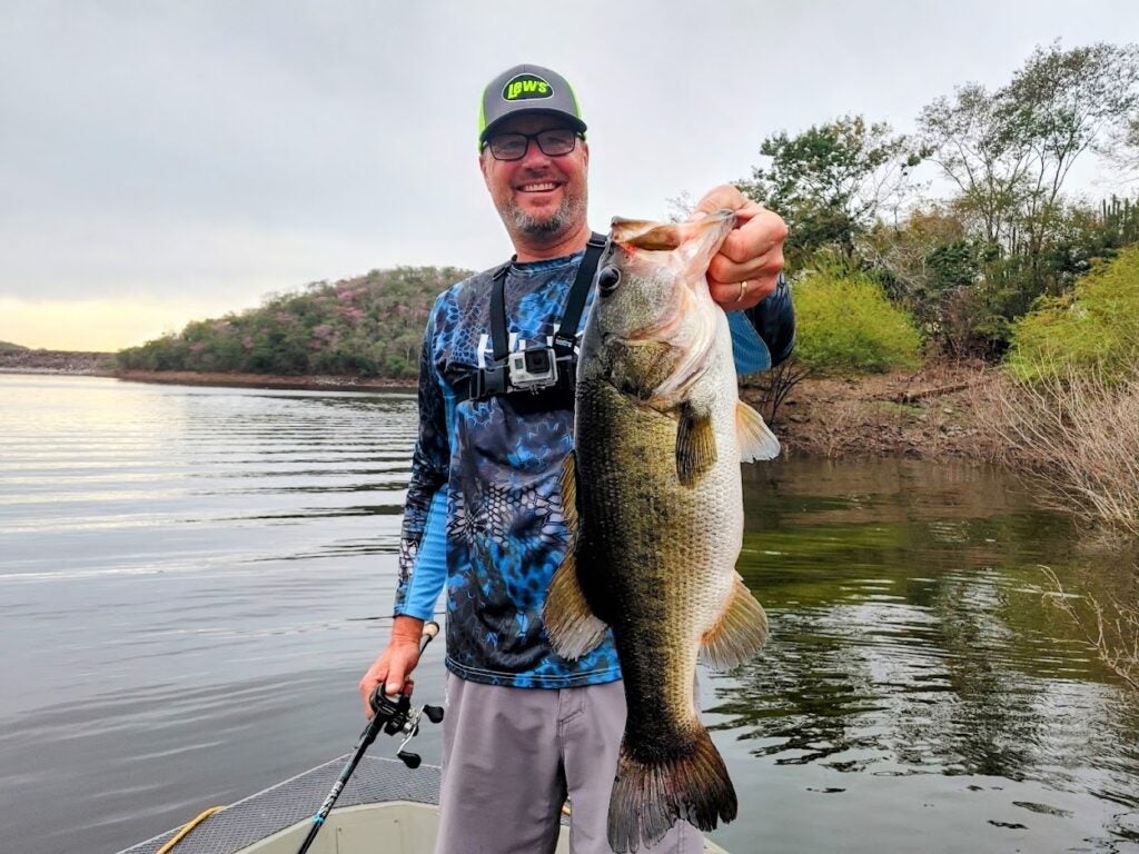 Author holding a bass caught on a fluke