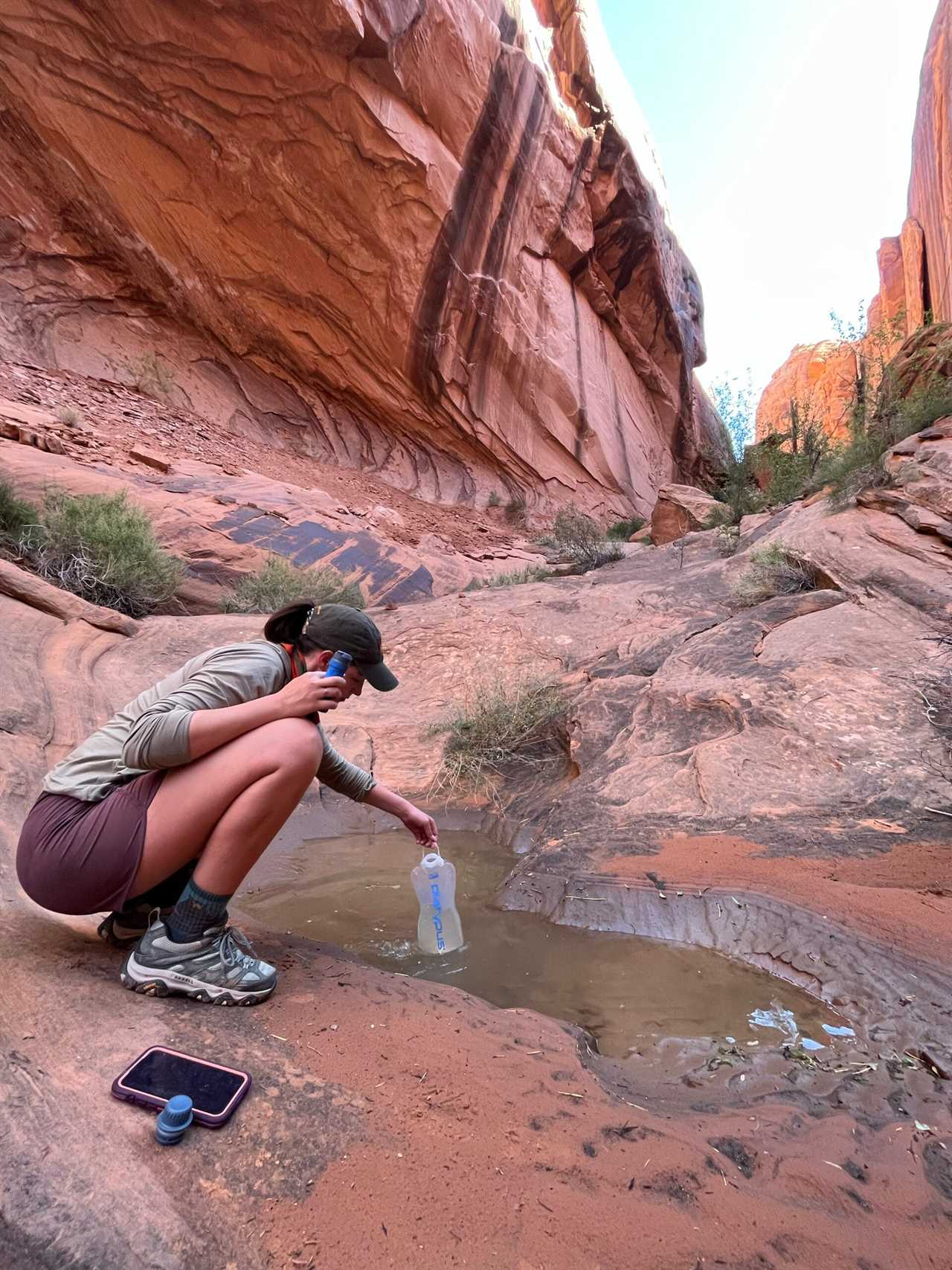 Author filling QuickDraw from muddy puddle.