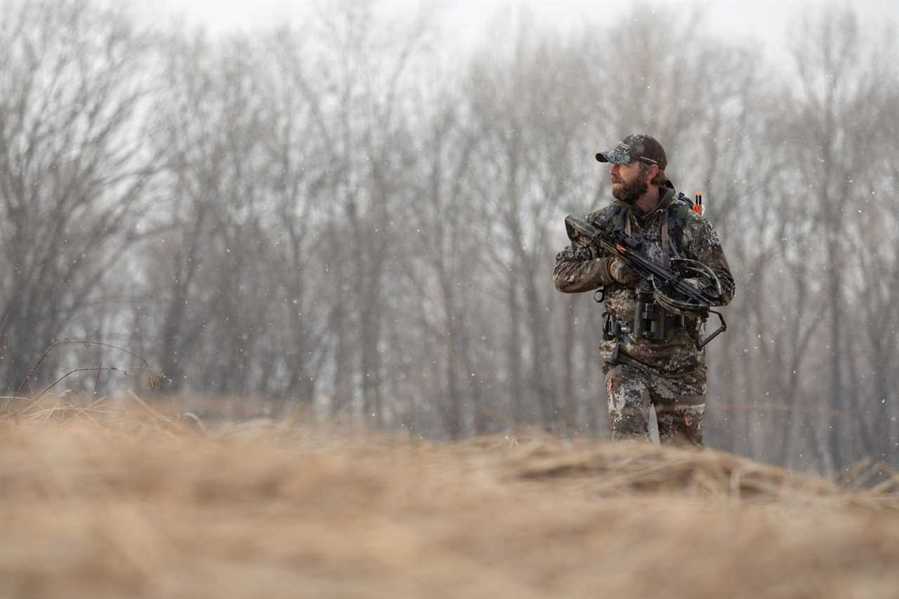 hunter walking with crossbow