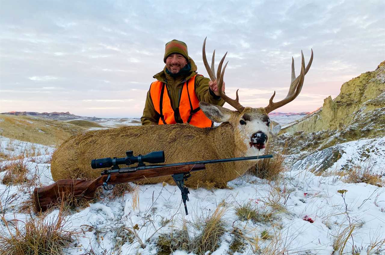 257 weatherby with mule deer in snow