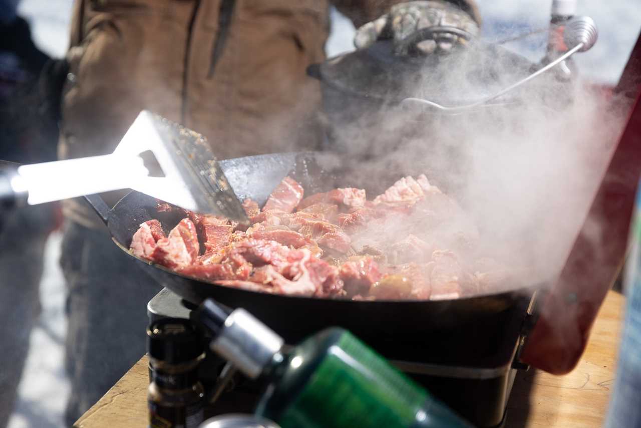 A skillet of hot steak with steam coming off it.