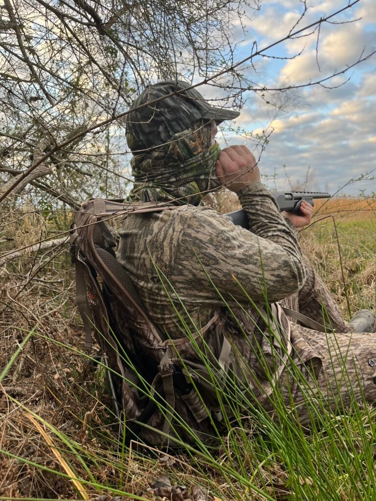 Turkey hunter sitting in some brush