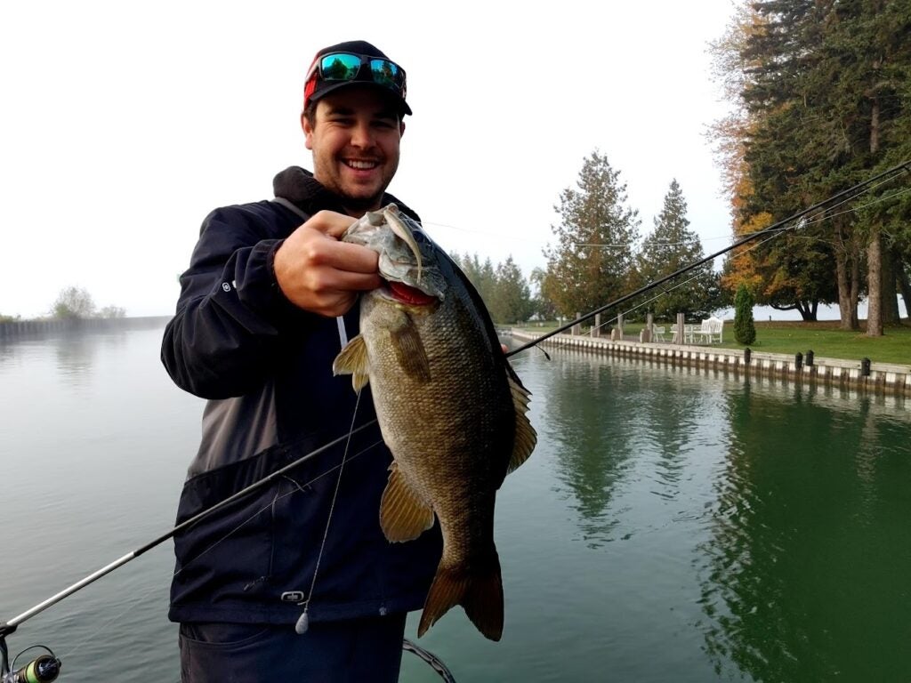 A man holding fish caught with the best smallmouth bass lure.