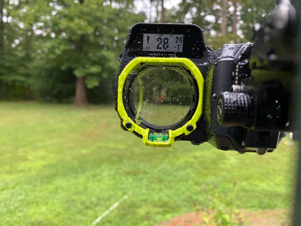 The Garmin Xero A1i Pro with raindrops covering the device