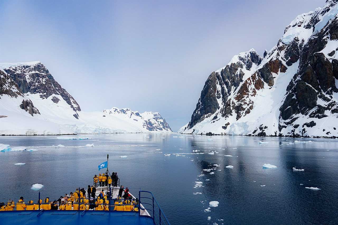 prow of ship is visible headed into icy, narrow waterway