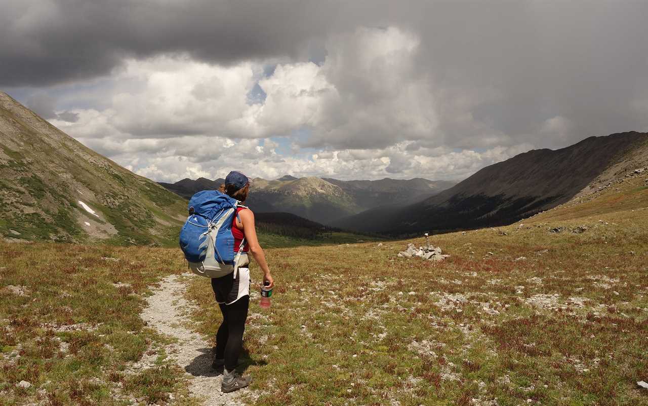 Woman hikes on a trail.