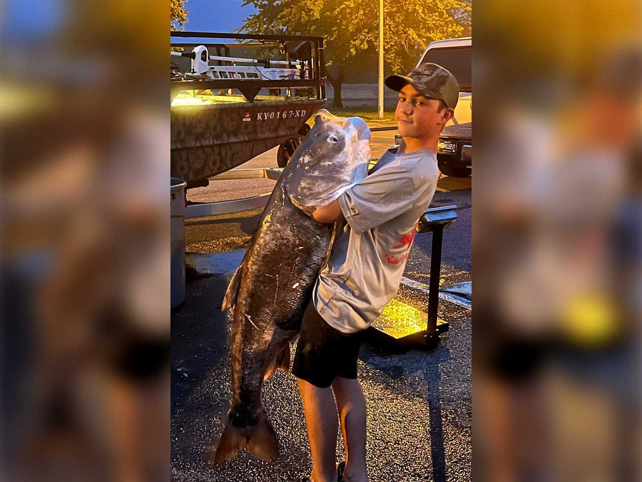 Scout Trader holds up the record-breaking bighead carp.