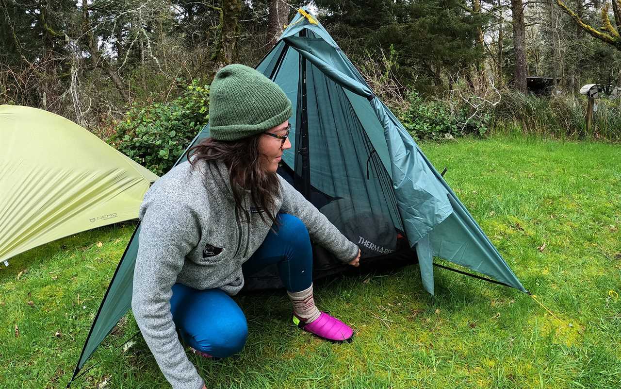 Author wears camp shoes outside tent.