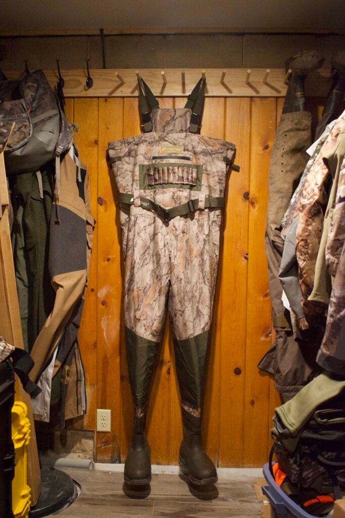 The best value duck hunting waders have a camo pattern and black boots 