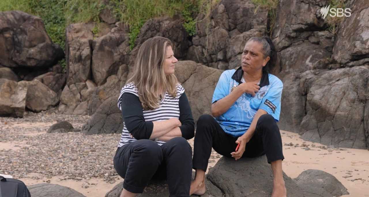 Julia Zemiro and Aunty Gwenda Jarrett sitting on a rock, talking (Kiama Coast)