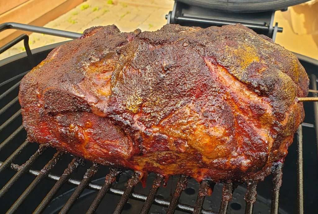 Smoky Pulled Pork Rub on  pork roast on  a smoker