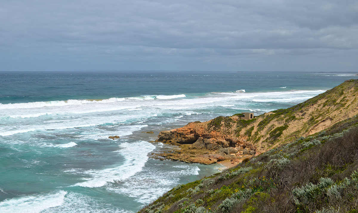 A gunnery, surrounded by wild seas, as seen from Cheviot Hill on the Point Nepean Walk