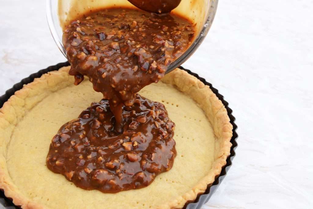 pouring pie filling into crust