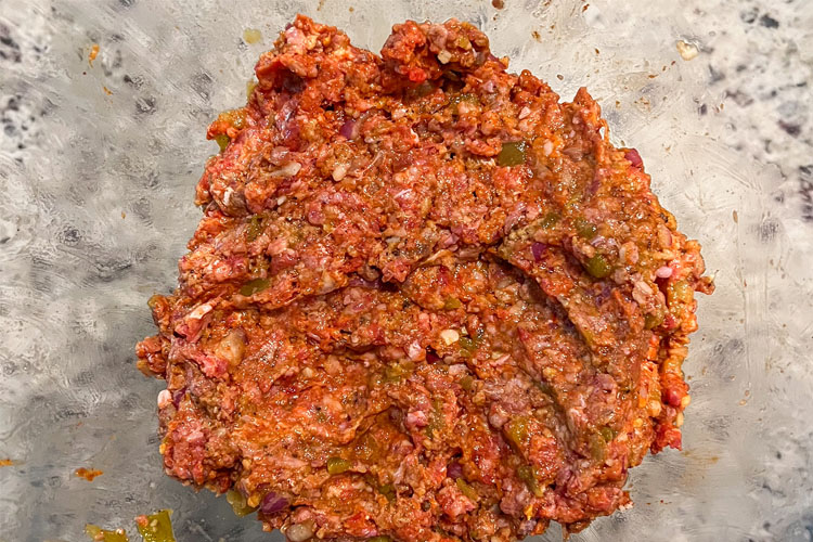 raw meatloaf mixture mixed together in a glass bowl