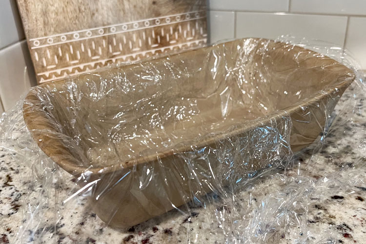 loaf pan lined with plastic wrap