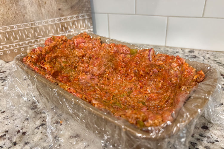 loaf pan lined with meatloaf mixture