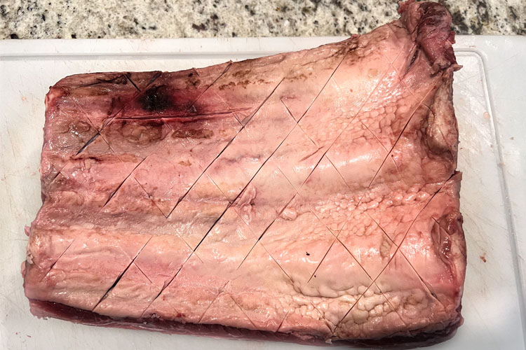 raw dino rib with diagonal slits in it