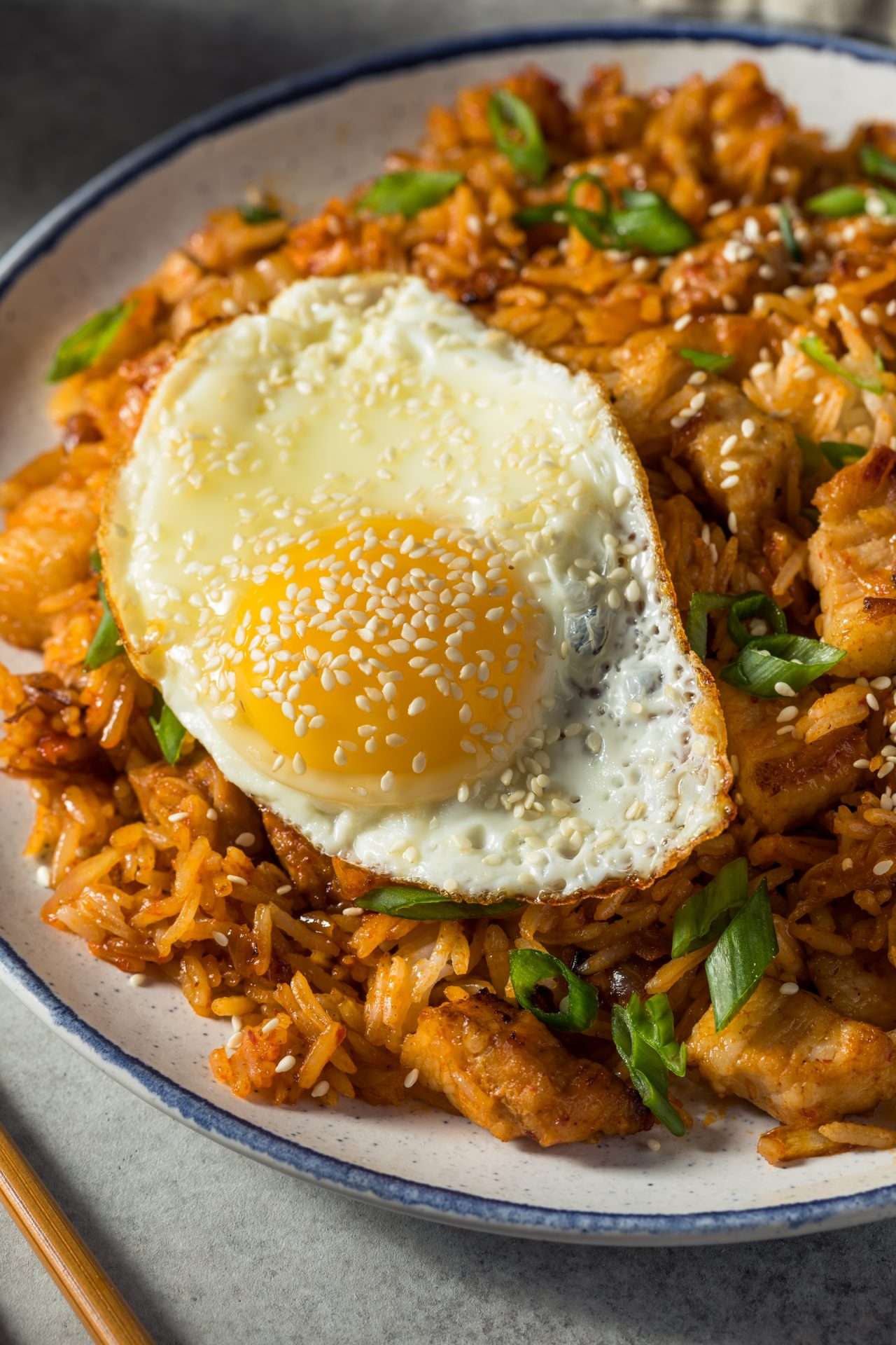 Fried Rice with Pork Belly and Kimchi cooked on a flat top griddle