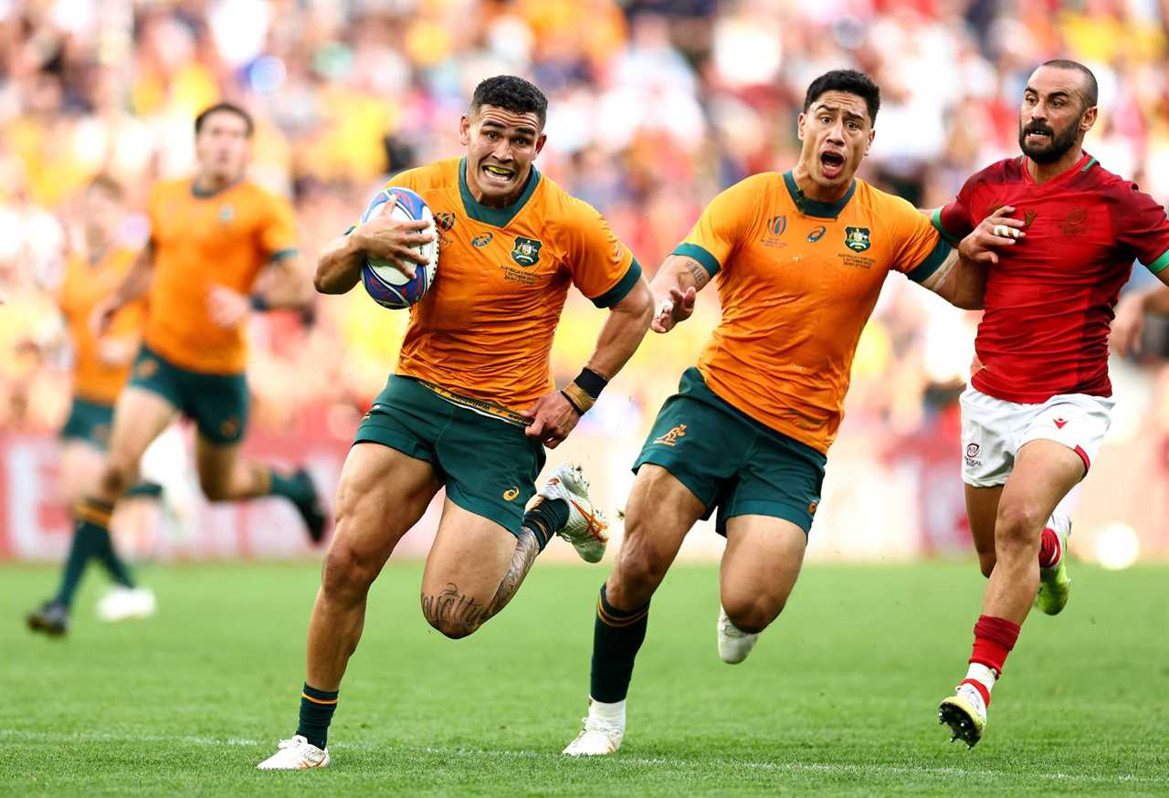 Izaia Perese of Australia breaks with the ball whilst under pressure from Samuel Marques of Portugal during the Rugby World Cup France 2023 match between Australia and Portugal at Stade Geoffroy-Guichard on October 01, 2023 in Saint-Etienne, France. (Photo by Chris Hyde/Getty Images)