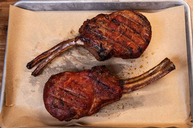 cooked pork chops on brown paper