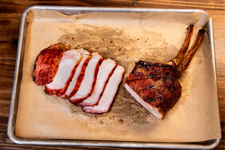 pork chop on brown paper with half of it sliced