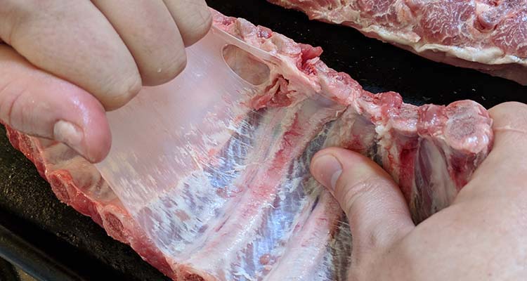 a person shows how to remove the membrane from pork ribs