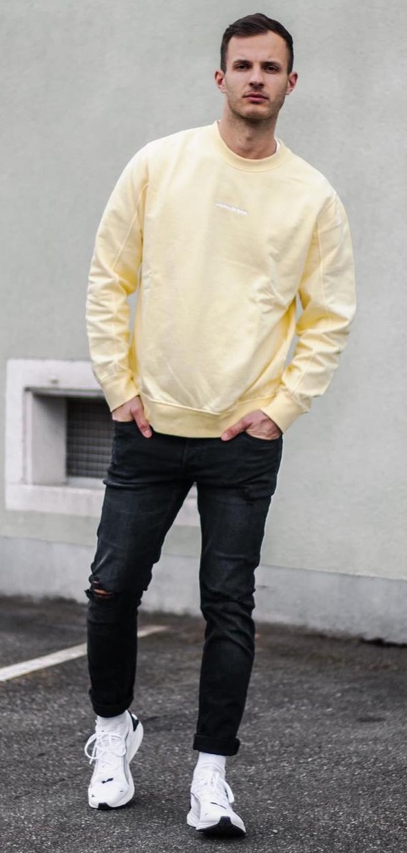 yellow sweatshirt with black denim and a sneaker brand - Puma