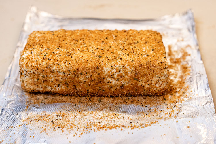 unsmoked seasoned cream cheese block on foil