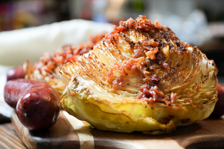 cabbage with bacon butter sauce and a sausage