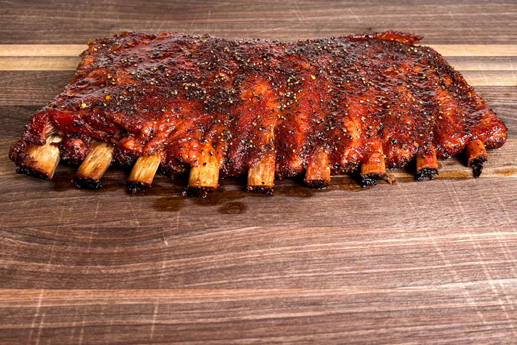 western caroline ribs on a wooden chopping board