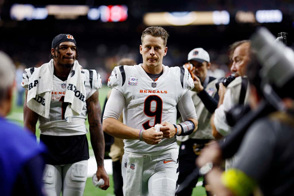 Joe Burrow #9 and Ja'Marr Chase #1 of the Cincinnati Bengals walk off the field after defeating the New Orleans Saints 30-26 at Caesars Superdome on October 16, 2022 in New Orleans, Louisiana.