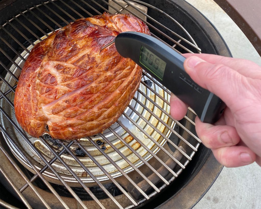 grill girl, checking ham with thermapen, big green egg