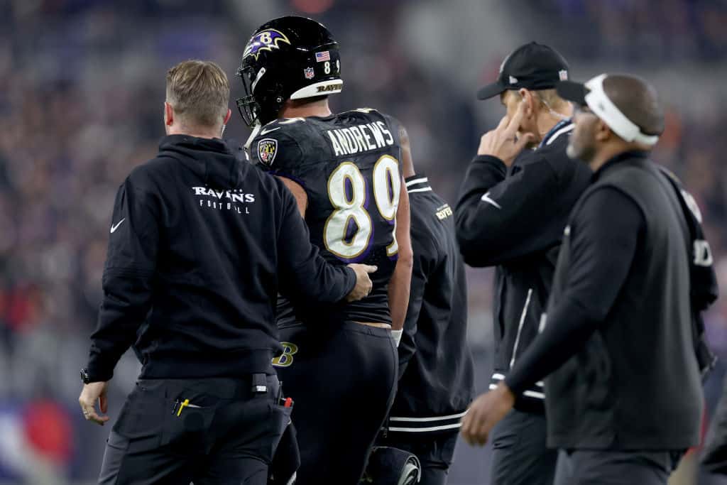 Mark Andrews #89 of the Baltimore Ravens is assisted off the field after being injured in a tackle by Logan Wilson #55 of the Cincinnati Bengals during the first quarter of the game at M&T Bank Stadium on November 16, 2023 in Baltimore, Maryland.