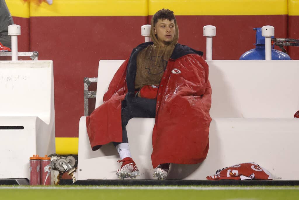 Patrick Mahomes #15 of the Kansas City Chiefs sits on the bench before their game against the Philadelphia Eagles at GEHA Field at Arrowhead Stadium on November 20, 2023 in Kansas City, Missouri.