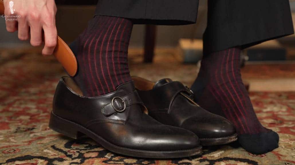 The leather covering on metal shoe horns can wear down over time; Midnight Blue and Burgundy Shadow Stripe Ribbed Socks from Fort Belvedere