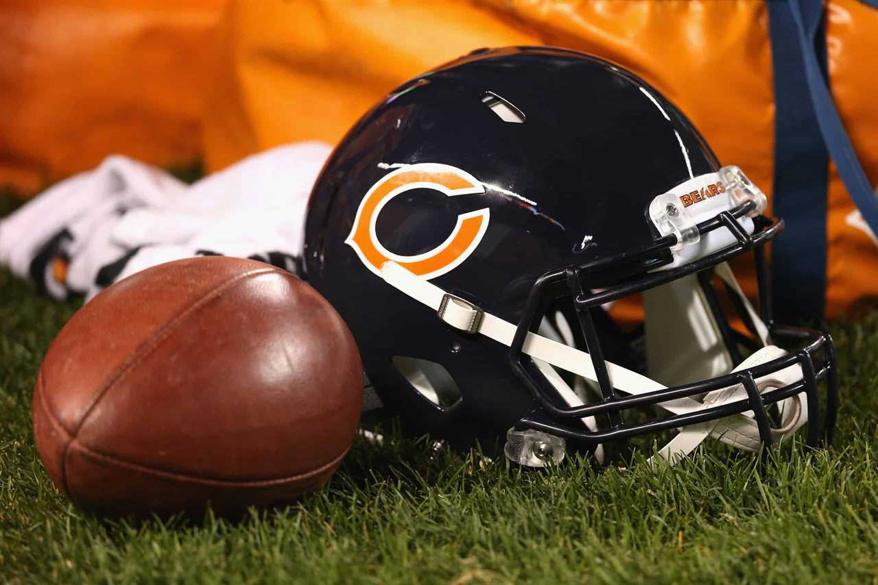 A ball and a Chicago Bears helmet are seen on the sidelines during a preseason game between the Bears and the Jacksonville Jaguars at Soldier Field on August 14, 2014 in Chicago, Illinois. The Bears defeated the Jaguars 20-19.