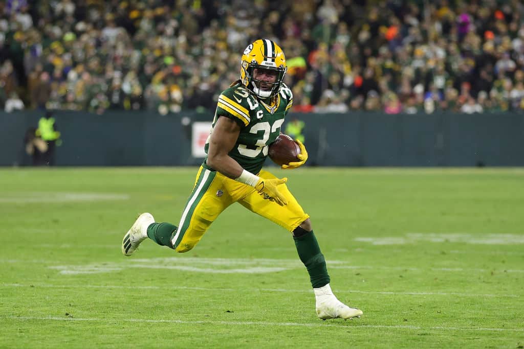 Aaron Jones #33 of the Green Bay Packers runs for yards during a game against the Los Angeles Rams at Lambeau Field on December 19, 2022 in Green Bay, Wisconsin. The Packers defeated the Rams 24-12.