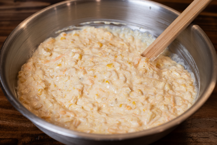 three cheese pudding ingredients mixed in a metal bowl