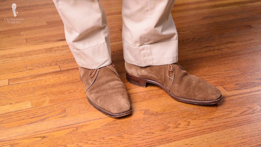 Traditional khaki colored chinos worn with light tan chukka boots