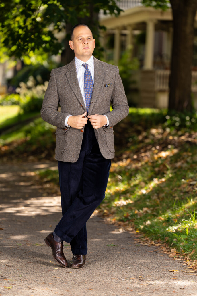 Photo of Raphael wearing Midnight Navy corduroy with tweed sport coat and blue tie