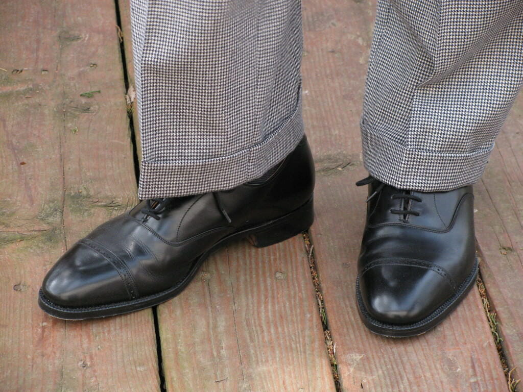 Houndstooth trousers with cuffs, which is a bit informal for a stroller, with quarter brogue oxfords in black