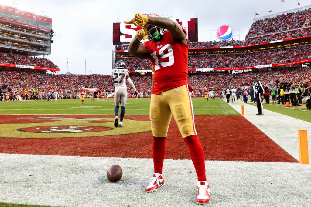 Deebo Samuel #19 of the San Francisco 49ers celebrates after scoring a 74 yard touchdown against the Seattle Seahawks during the fourth quarter in the NFC Wild Card playoff game at Levi's Stadium on January 14, 2023 in Santa Clara, California.