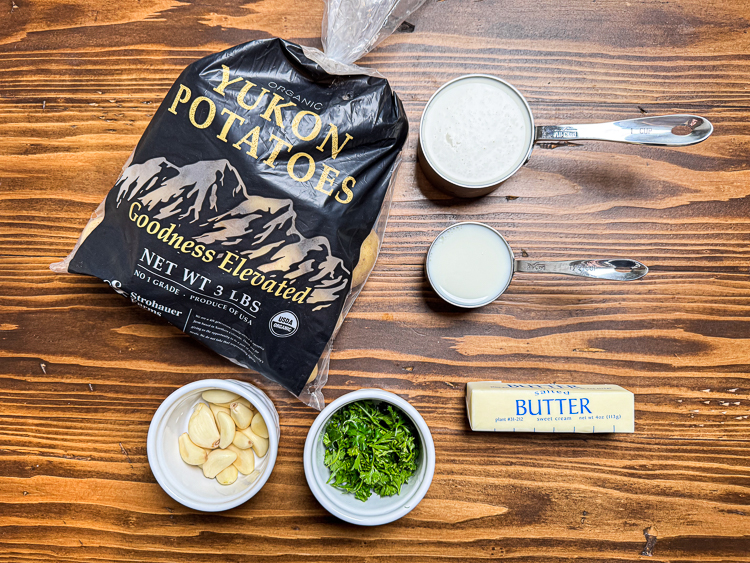 ingredients for smoked garlic mashed potatoes on a wooden board