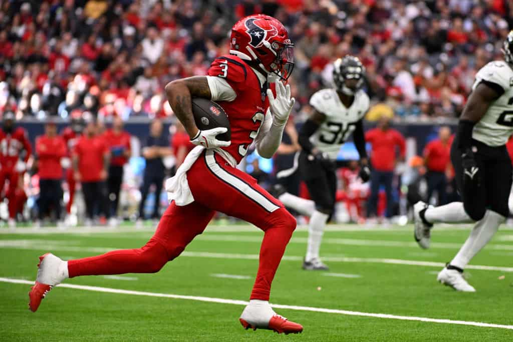 Tank Dell #3 of the Houston Texans runs with the ball during the second half against the Jacksonville Jaguars at NRG Stadium on November 26, 2023 in Houston, Texas.