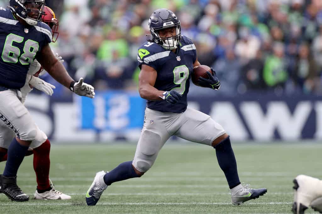 Kenneth Walker III #9 of the Seattle Seahawks carries the ball against the Washington Commanders during the first quarter at Lumen Field on November 12, 2023 in Seattle, Washington.