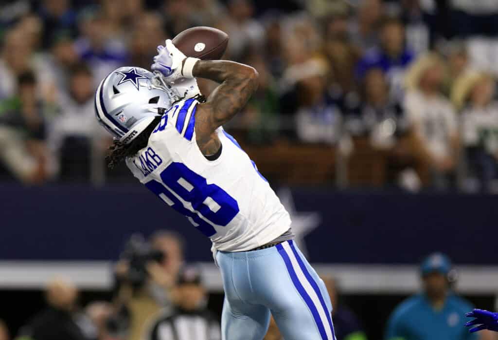 ARLINGTON, TEXAS - NOVEMBER 30: Wide receiver CeeDee Lamb #88 of the Dallas Cowboys makes a catch in the end zone for a touchdown during the 1st quarter of the game against the Seattle Seahawks at AT&T Stadium on November 30, 2023 in Arlington, Texas.