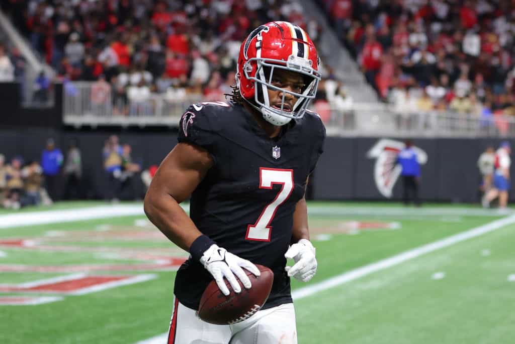 Bijan Robinson #7 of the Atlanta Falcons reacts after scoring a receiving touchdown in the fourth quarter of the game against the New Orleans Saints at Mercedes-Benz Stadium on November 26, 2023 in Atlanta, Georgia.