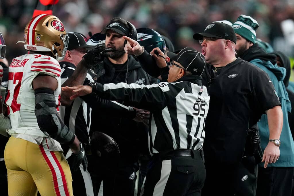 PHILADELPHIA, PENNSYLVANIA - DECEMBER 03: Dre Greenlaw #57 of the San Francisco 49ers exchanges words with Philadelphia Eagles head coach Nick Sirianni and Dom DiSandro at Lincoln Financial Field on December 03, 2023 in Philadelphia, Pennsylvania. Dre Greenlaw #57 of the San Francisco 49ers and Dom DiSandro of the Eagles were disqualified after the altercation.